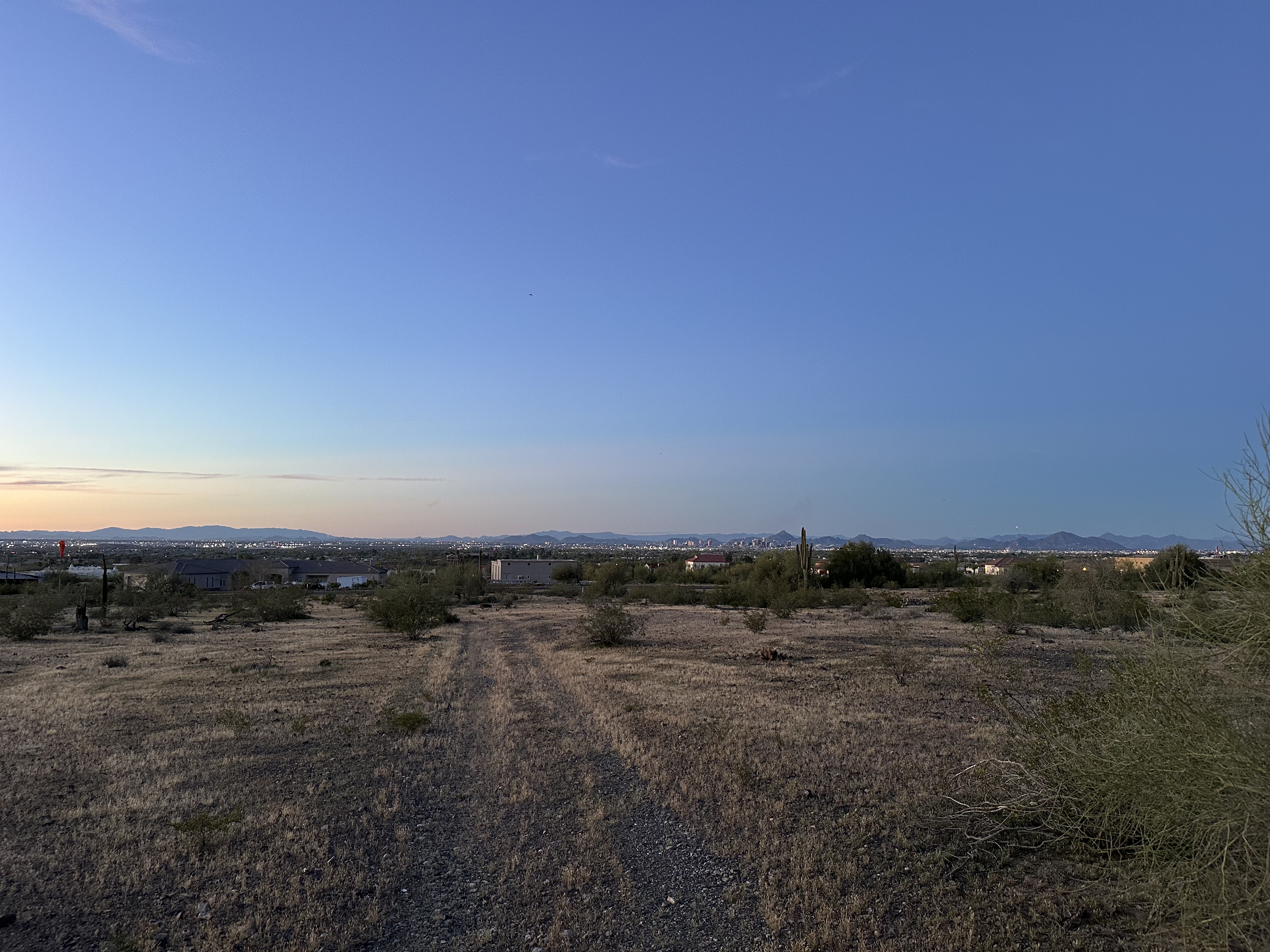 Panoramic view of desert lot with Phoenix skyline on the horizon